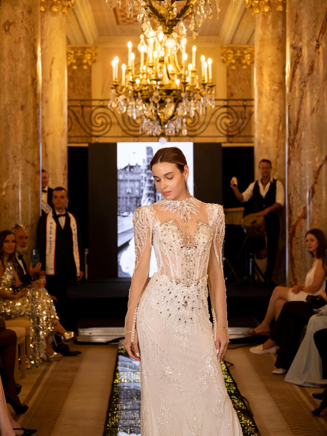 Black A-line gown with a deep V and dense floral lace, from the Lidiia Krejci salon.